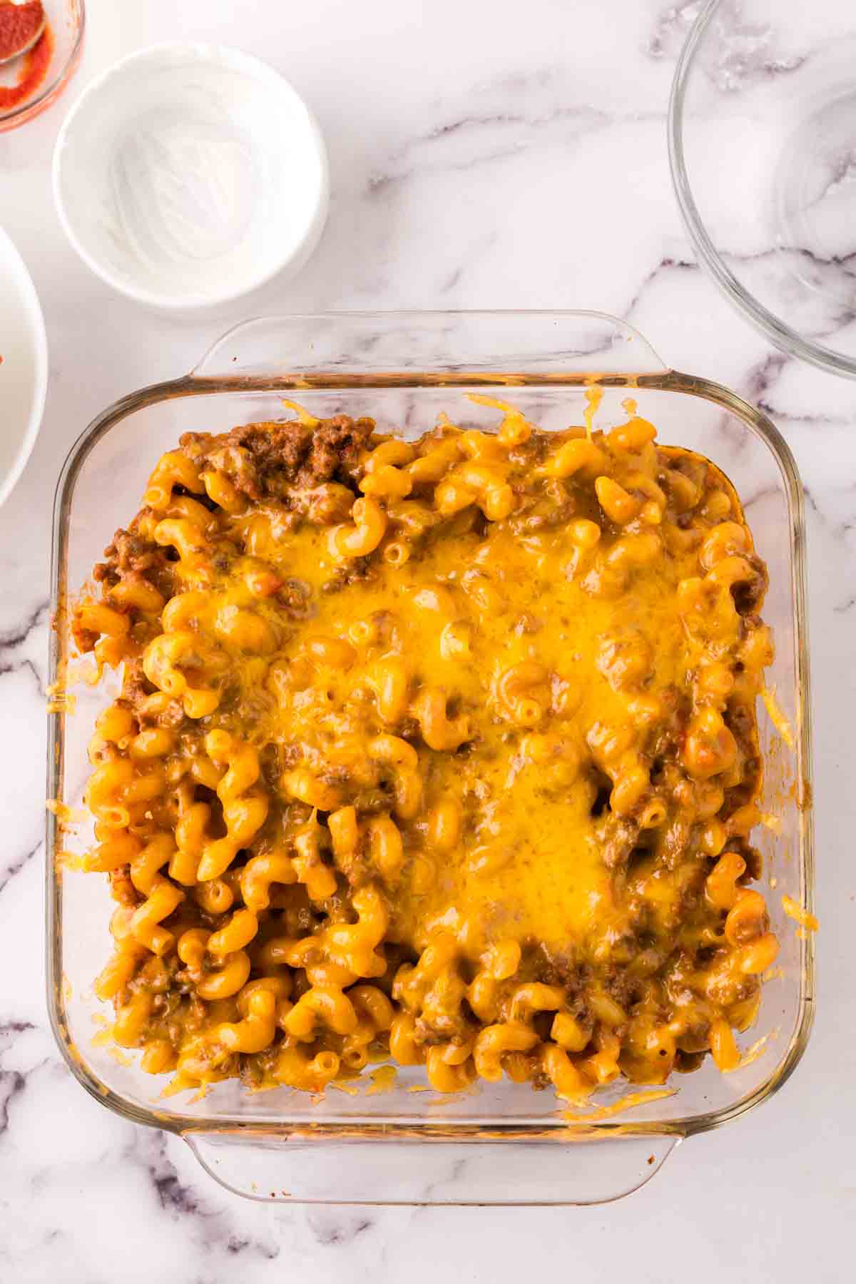 small clear baking dish with the cheeseburger casserole recipe.