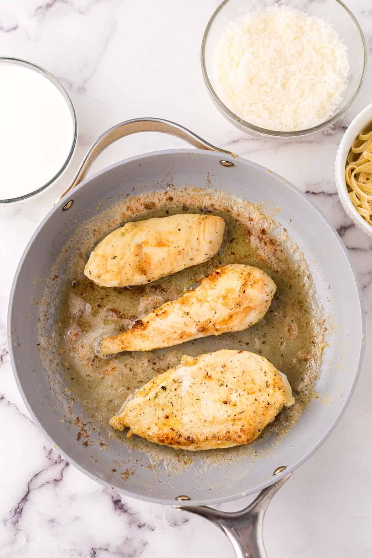 chicken breast cooking off in order to be added to the chicken fettuccine alfredo recipe.