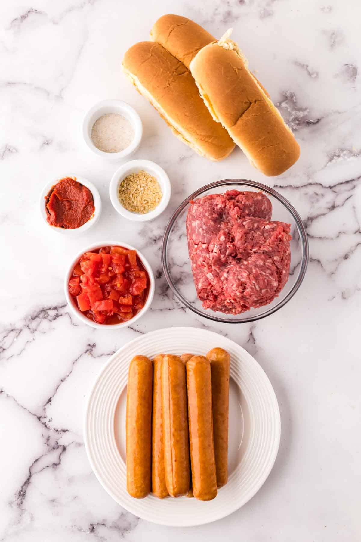 portion bowls each with raw ingredients to make chili dogs.