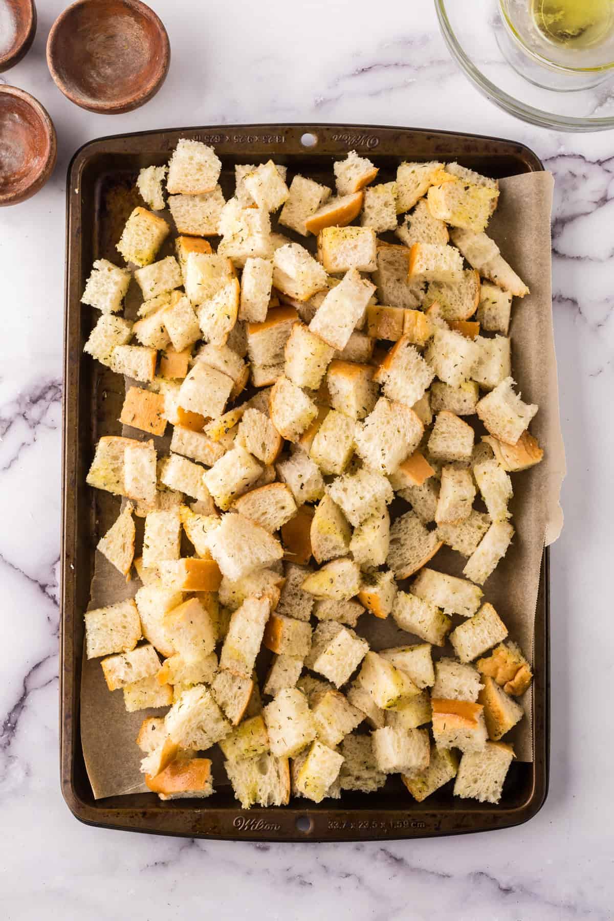 baking sheet with seasoned bread to make croutons.