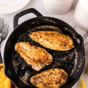 baked chicken breast in a cast iron skillet for the Lemon Pepper Chicken Recipe.