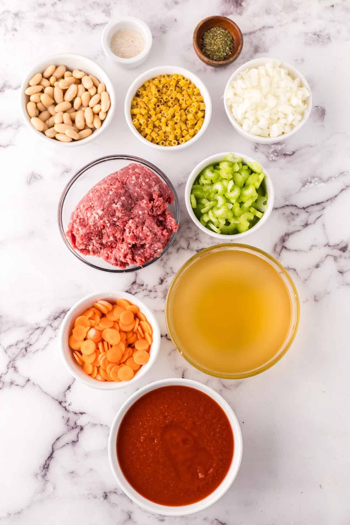 portion bowls each with raw ingredients to make Pasta Fagioli Soup.