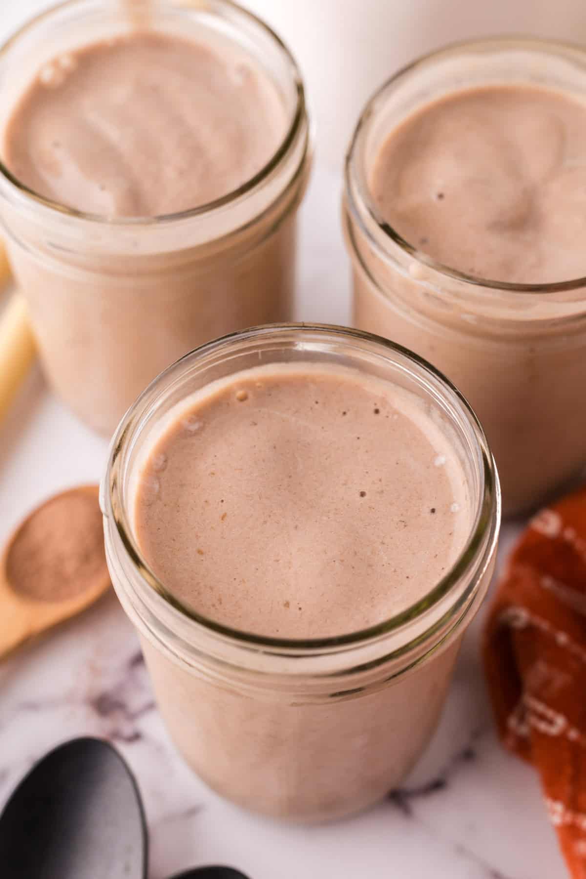 glass mason jars with protein shakes inside.