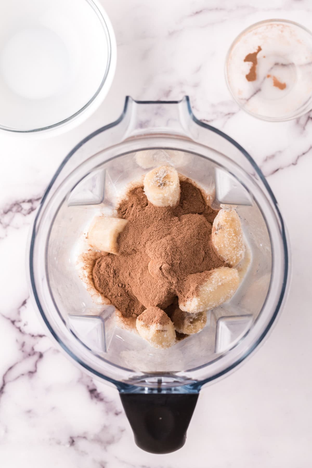 blender with fresh ingredients for a protein shake recipe.