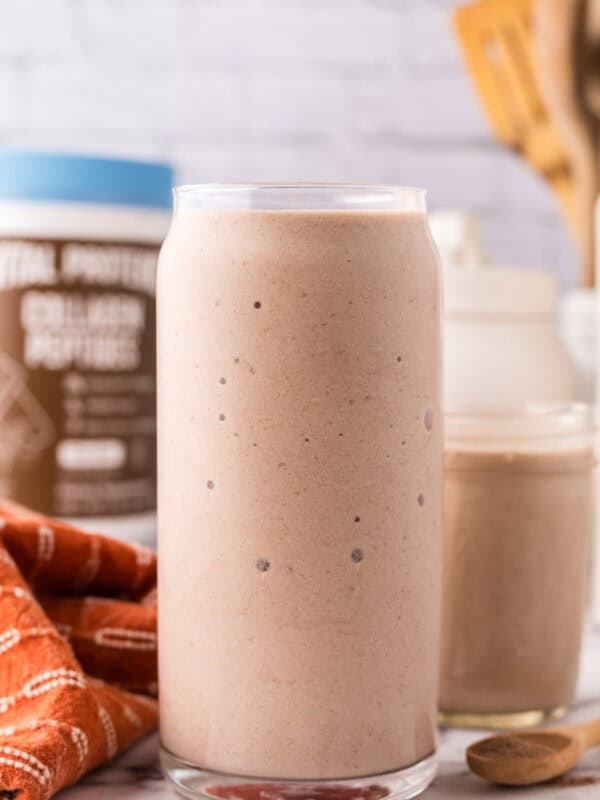 tall glass jar with a protein shake.