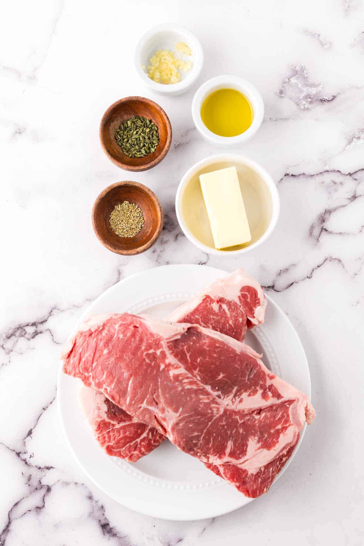 portion bowls each with raw ingredients to make reverse sear steak.