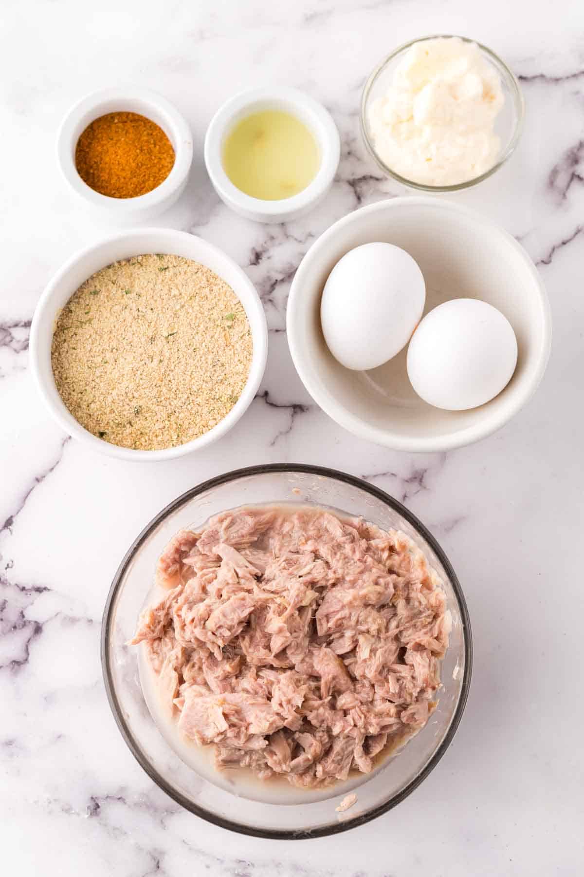 portion bowls each with raw ingredients to make the tuna patties recipe.