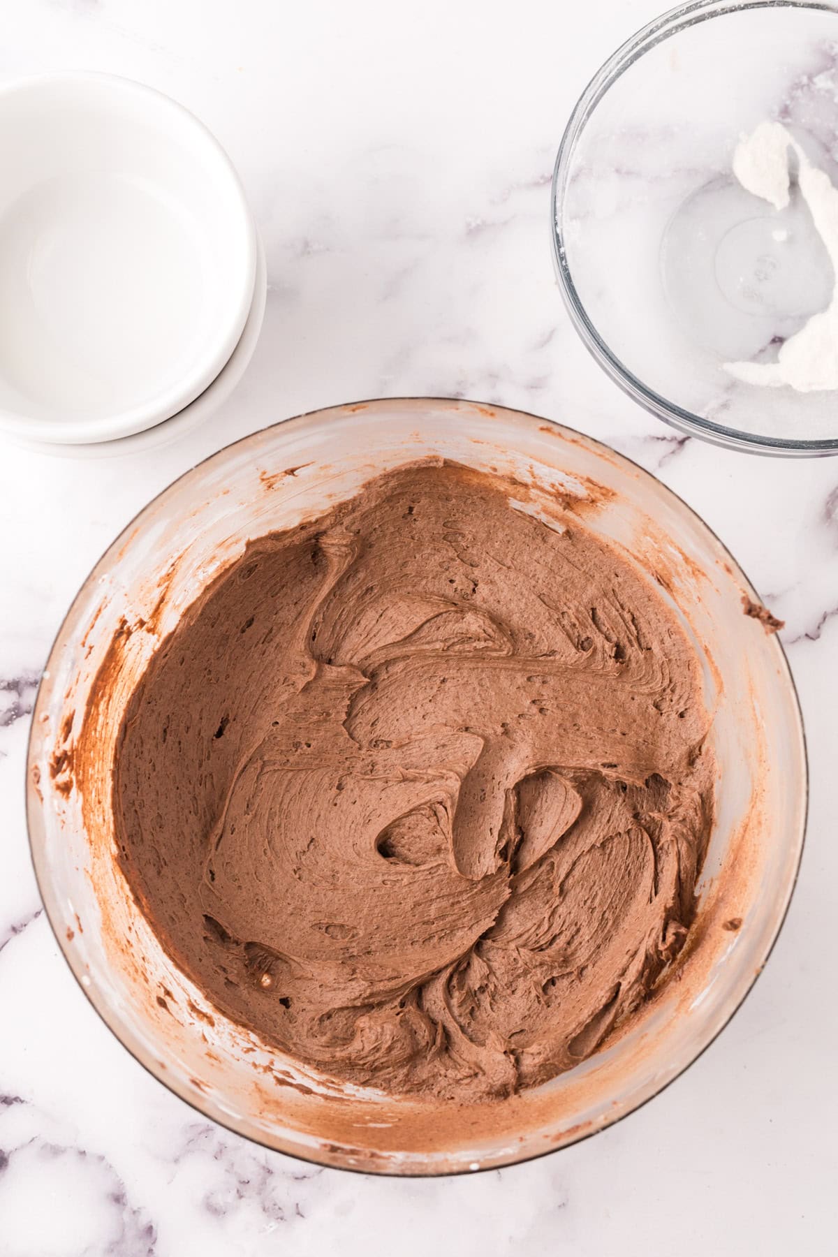 clear mixing bowl of chocolate frosting.
