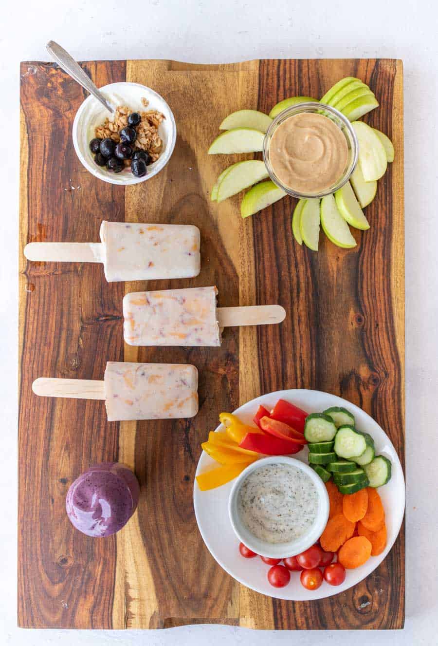 stony field after school snacks on a wooden board.