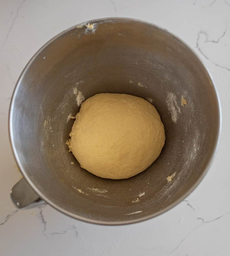Ball of sourdough for hamburger buns in a bowl ready for the resting period. 