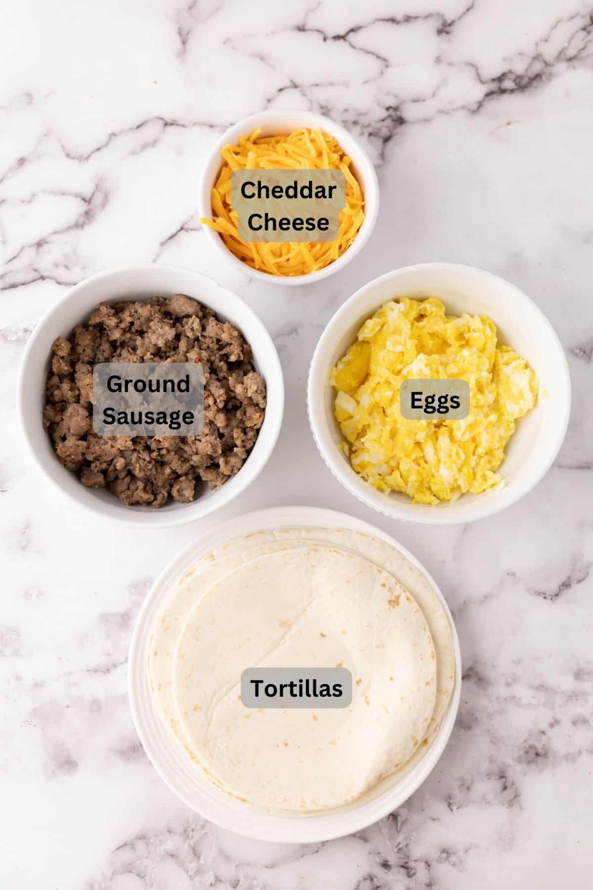 portion bowls each with digitally labeled raw ingredients to make breakfast quesadillas.