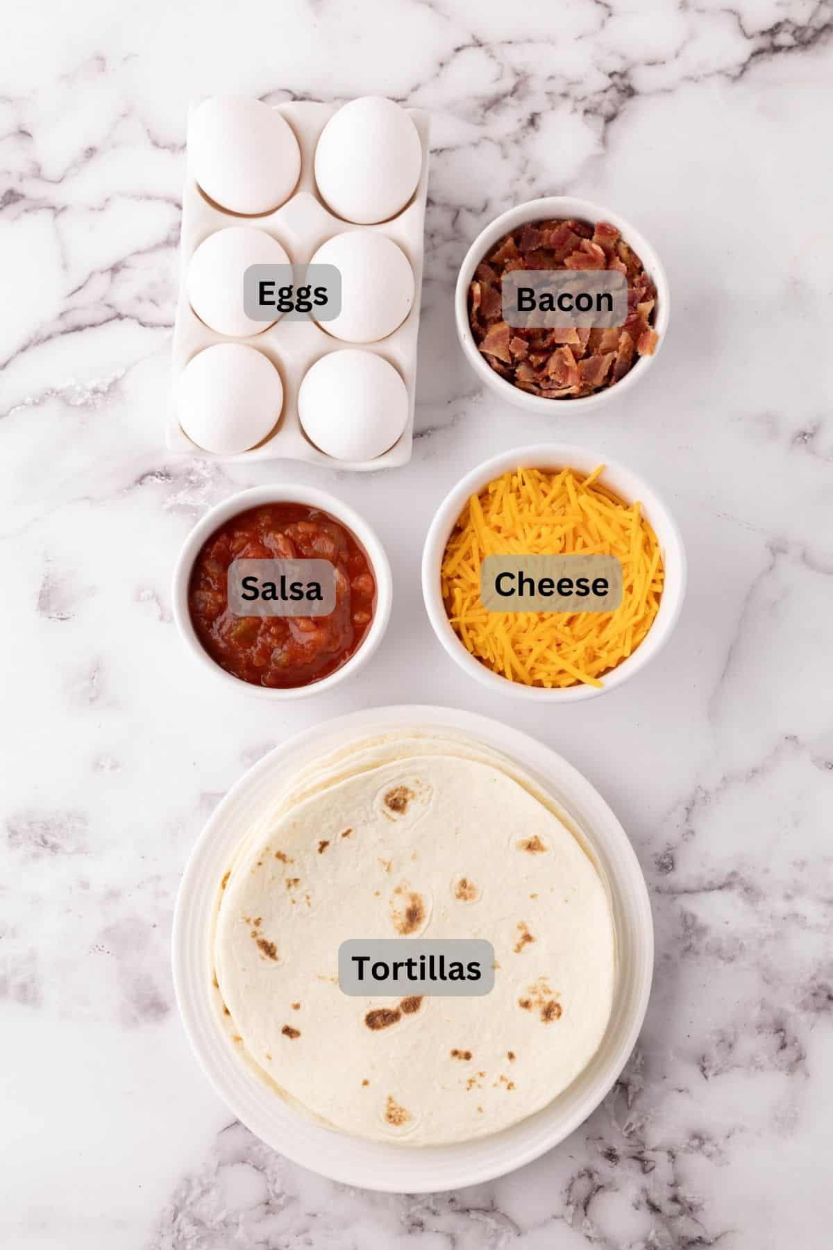 portion bowls each with digitally labeled raw ingredients to make Breakfast Tacos.