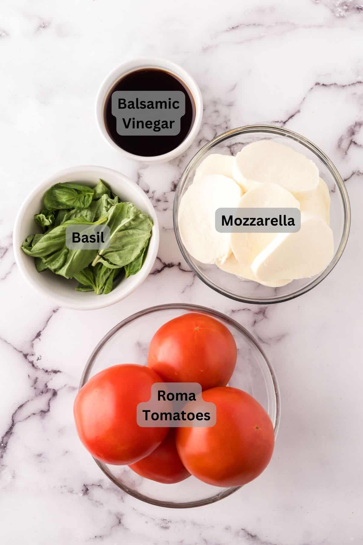 portion bowls each with digitally labeled raw ingredients to make caprese salad.