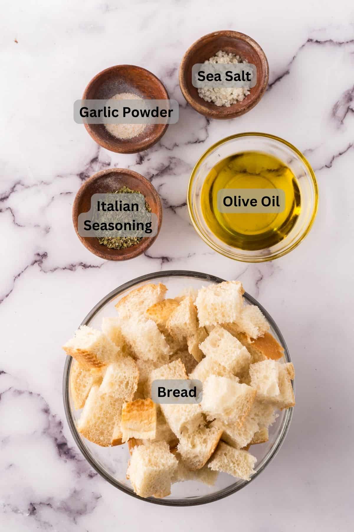 portion bowls each with digitally labeled raw ingredients to make homemade croutons.