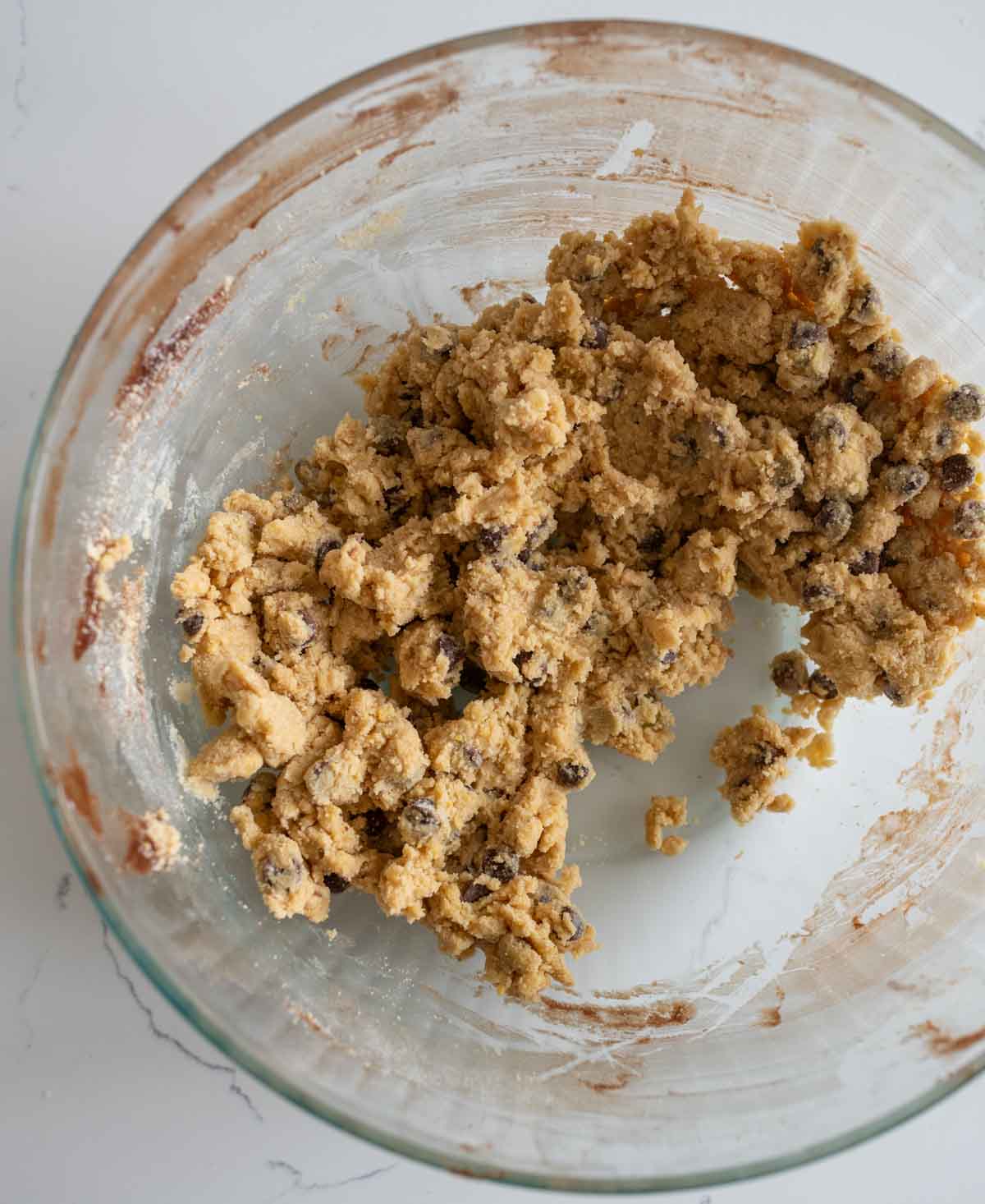 clear glass mixing bowl with cookie dough batter for box made brookies.