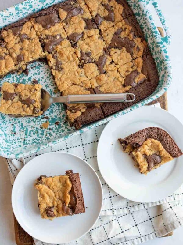 square cut brookies in the pan and two serving plates.