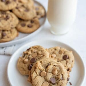 chocolate chip cookies with peanut butter chips in a pile on a round plate.