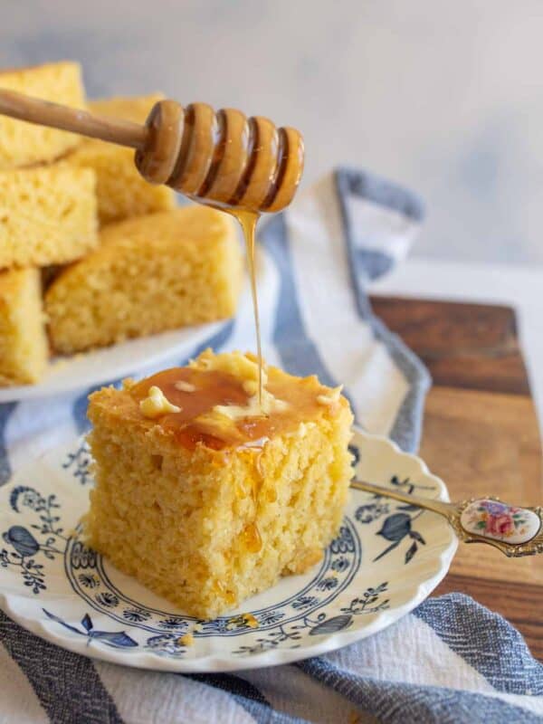 cornbread with butter and honey on a plate