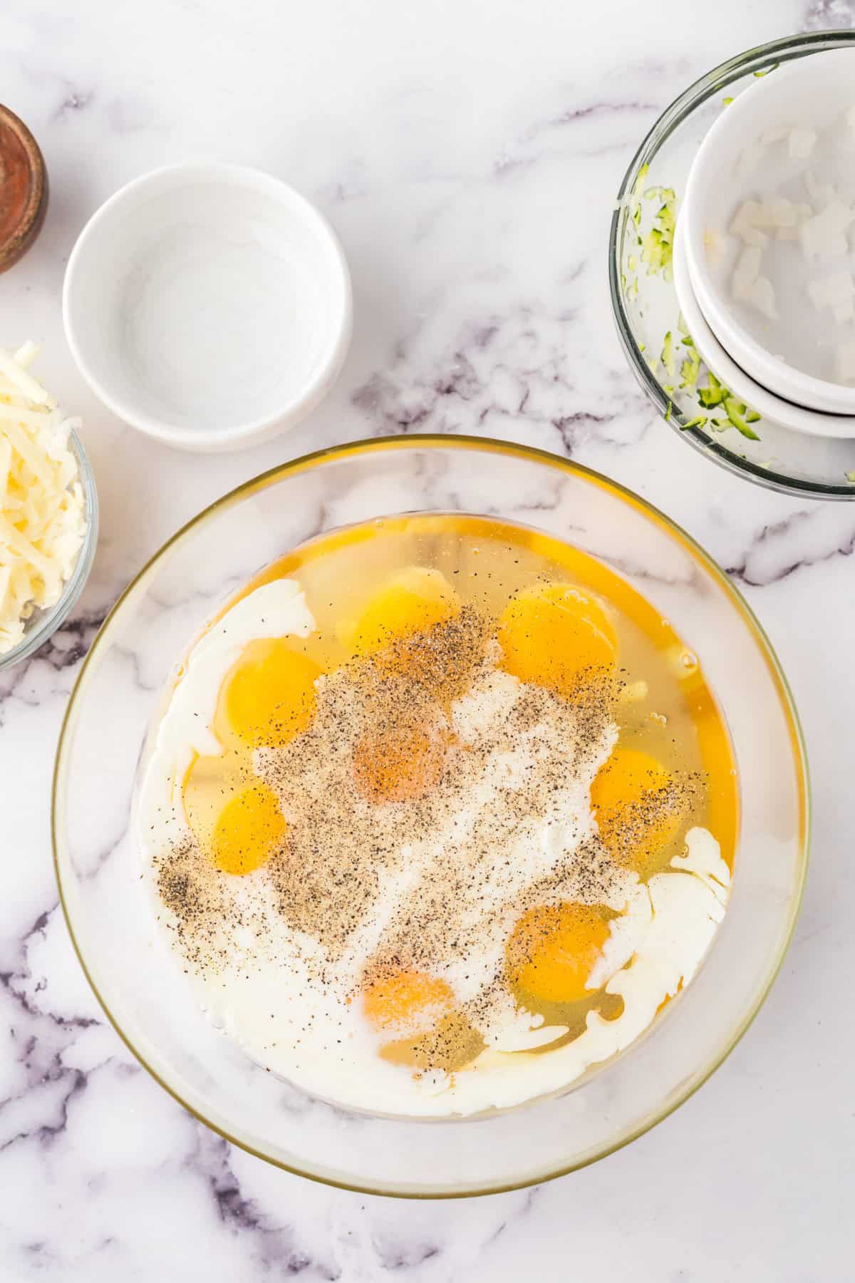 clear mixing bowl in the process of making farmhouse egg bake recipe.