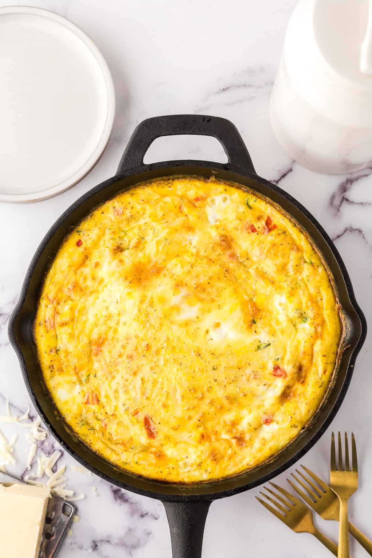 Farmhouse egg bake recipe whole in a cast iron pan.