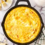 Farmhouse egg bake recipe whole in a cast iron pan.