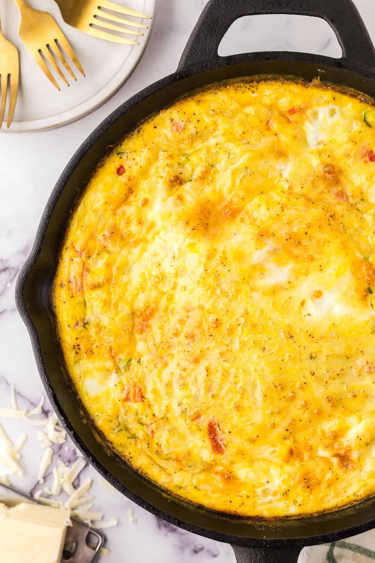 Farmhouse egg bake recipe whole in a cast iron pan.