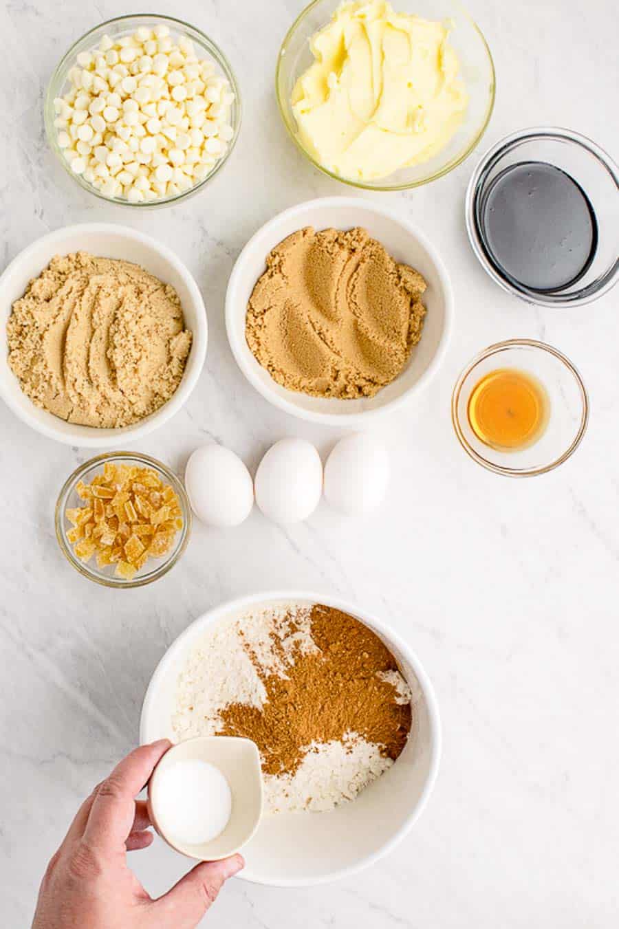 Portion bowls each with raw ingredients to make gingerbread blondies.