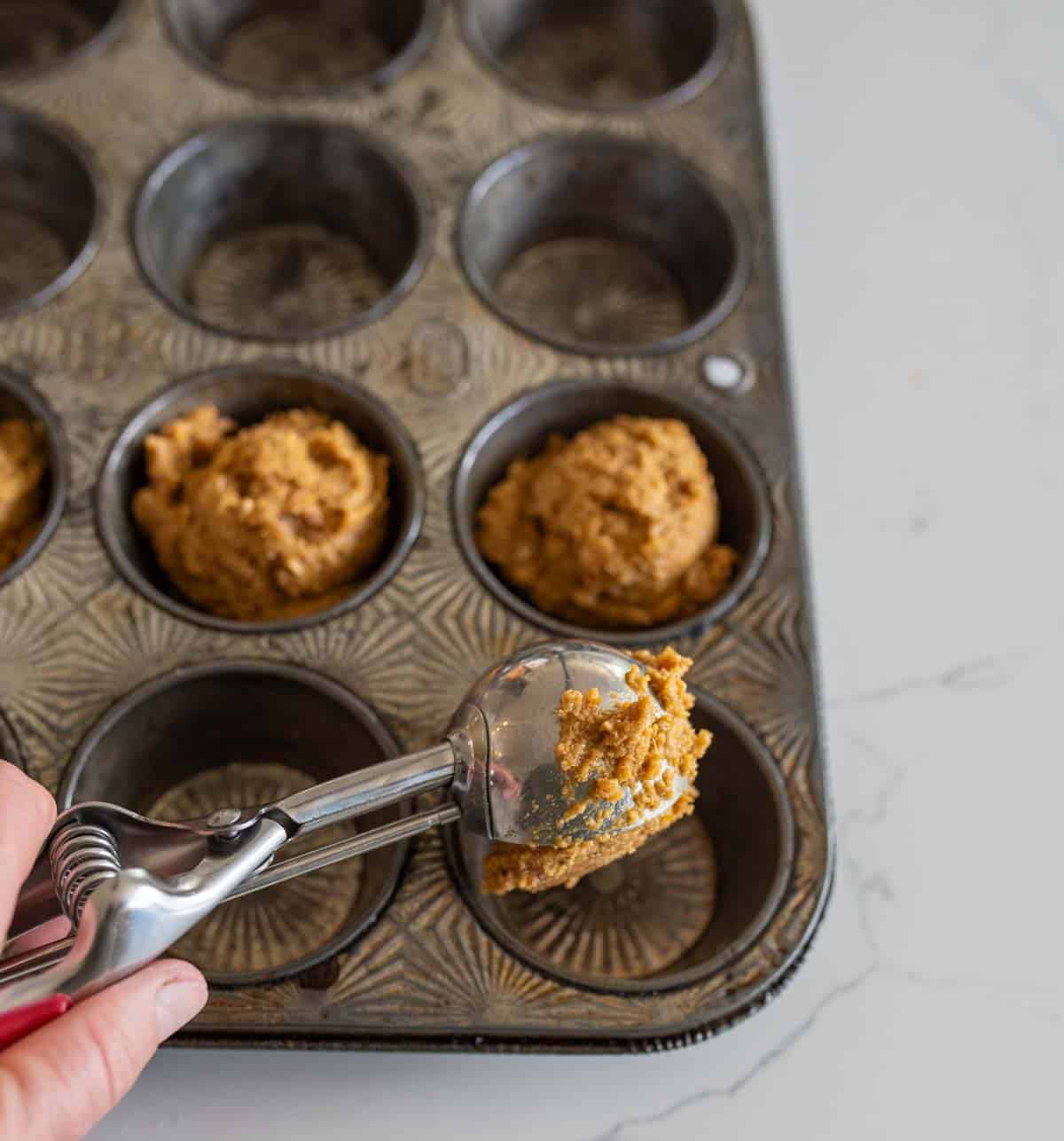 healthy pumpkin muffin dough into the tin.