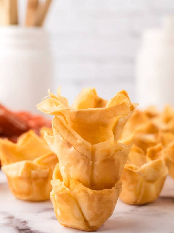 three homemade phyllo cup recipe stacked on the counter.