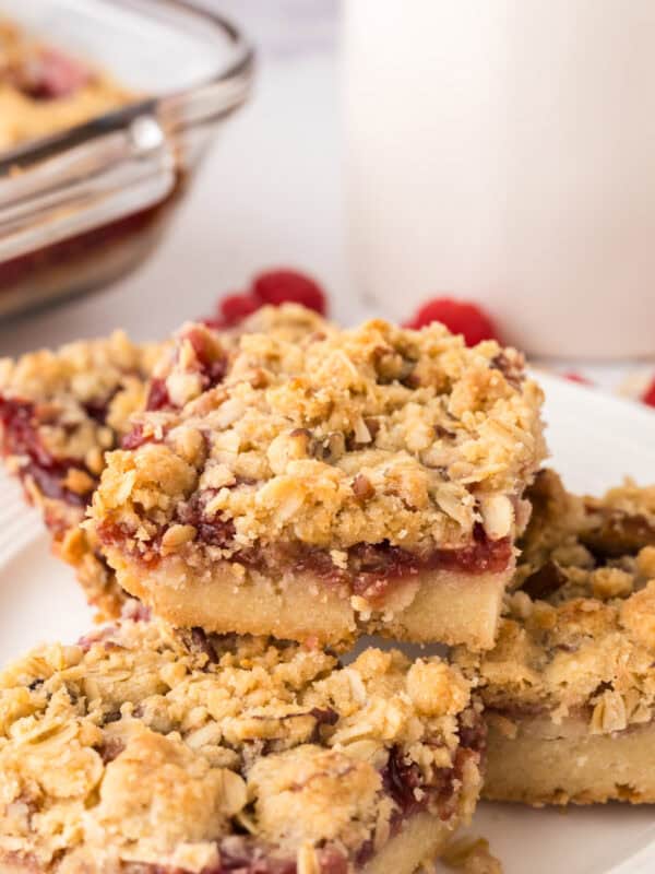 round white plate with squares of raspberry streusel bars.