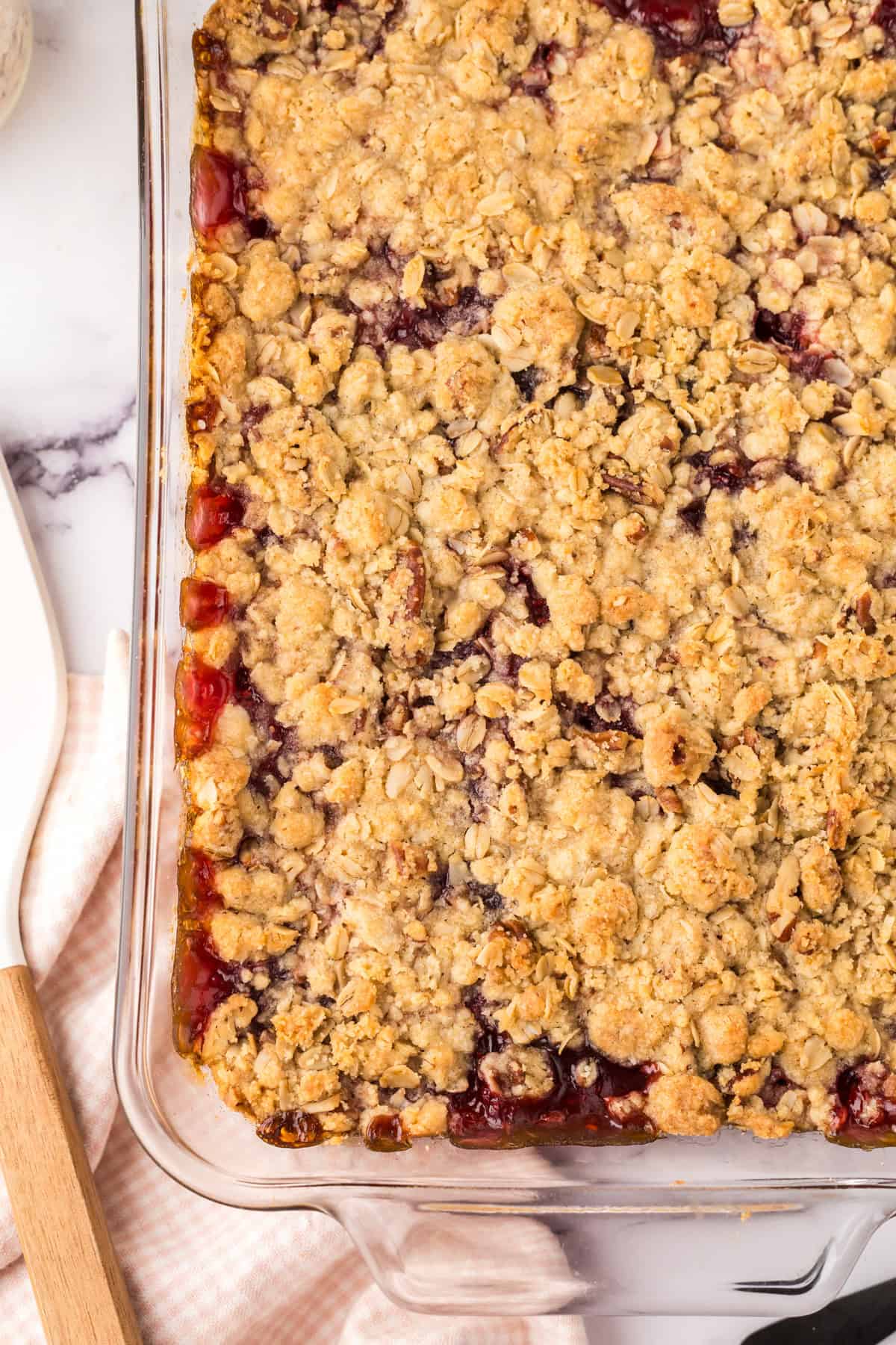 clear glass dish with raspberry streusel bars.