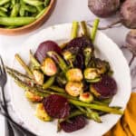 Roasted Spring Vegetables Recipe on a round white plate.