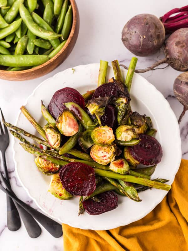 Roasted Spring Vegetables Recipe on a round white plate.