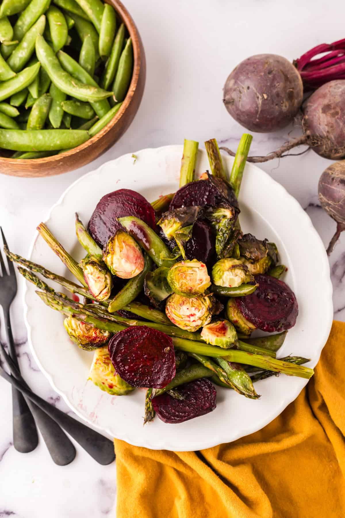 Roasted Spring Vegetables Recipe on a round white plate.