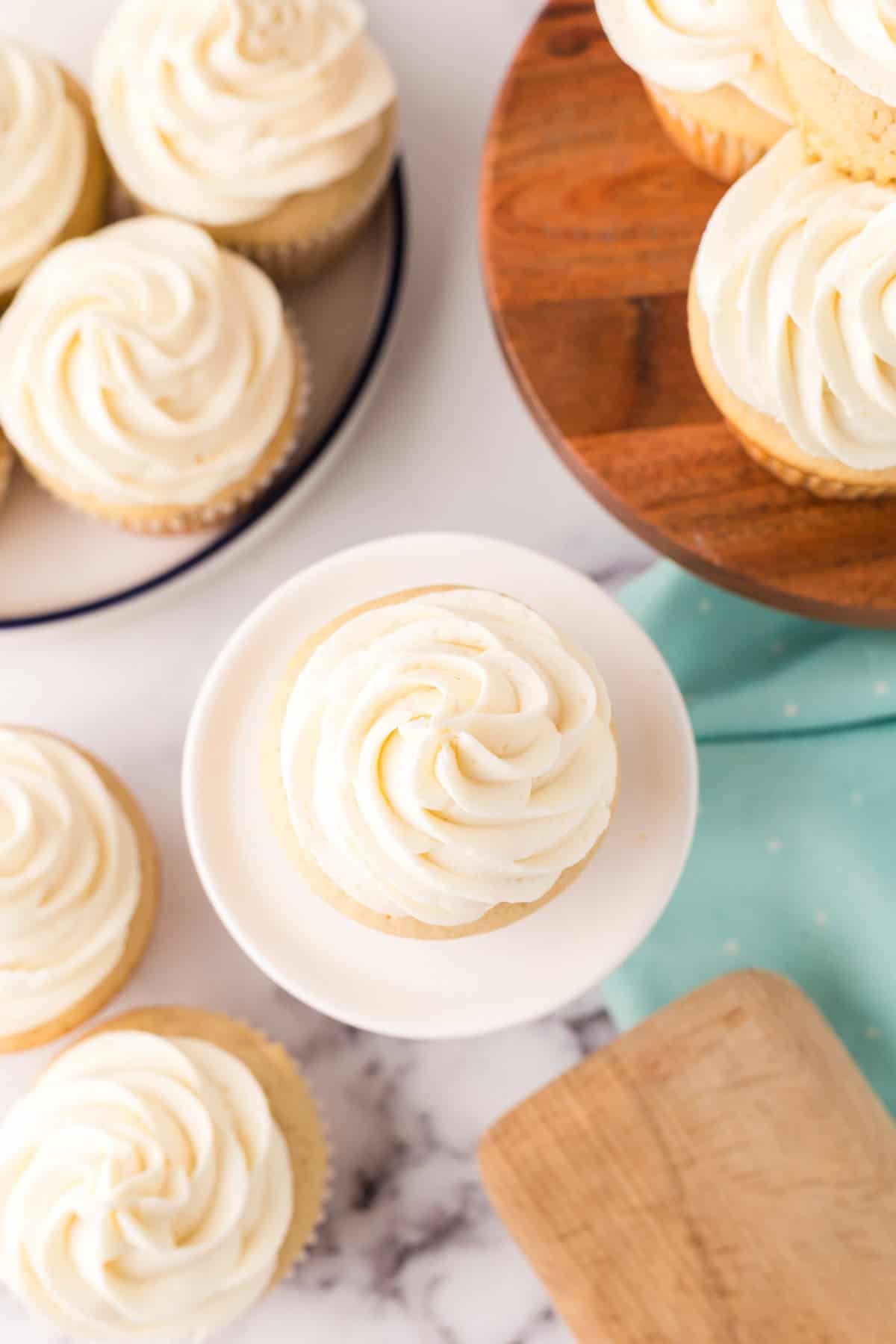 Copycat vanilla cupcakes with vanilla frosting on top in a swirl.