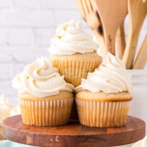 Copycat vanilla cupcakes with vanilla frosting on top in a swirl.