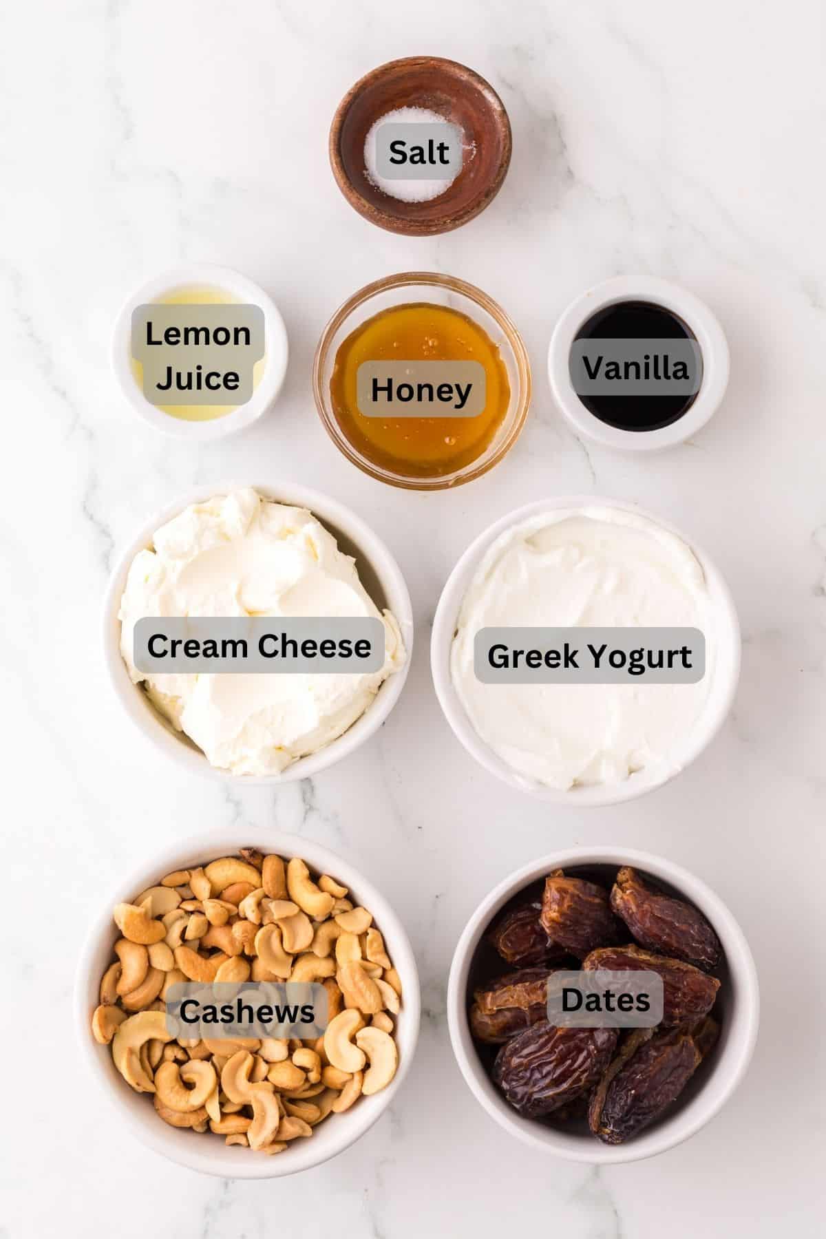 portion bowls each with digitally labeled raw ingredients to make healthy no-bake cheesecake.