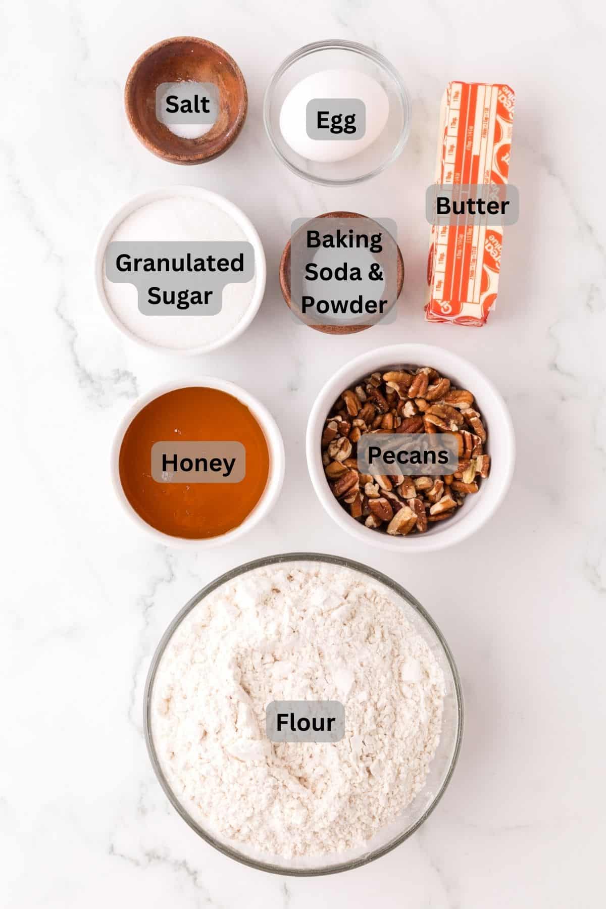 portion bowls each with digitally labeled raw ingredients to make honey pecan sliced cookies.