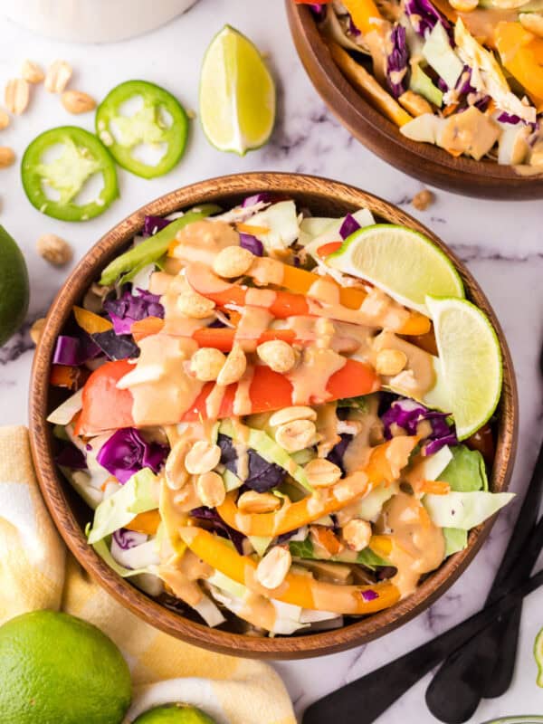 wooden salad bowl with asian chicken salad with peanut dressing.