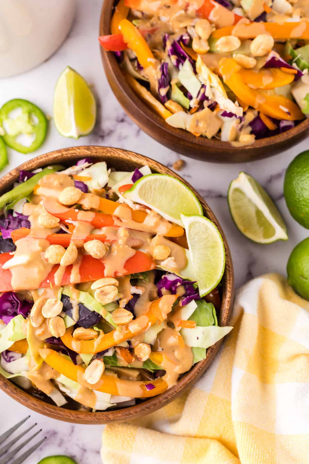 wooden salad bowl with asian chicken salad with peanut dressing.