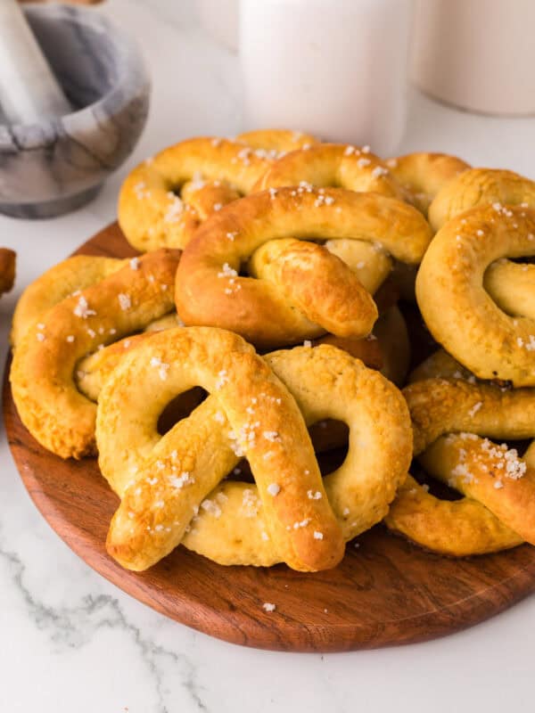 wooden board with a pile of big soft pretzels.