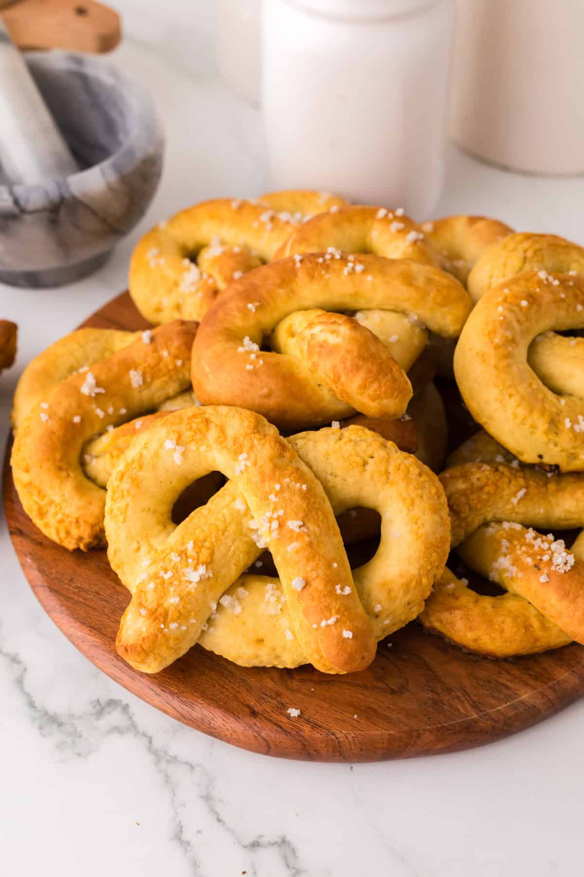 wooden board with a pile of big soft pretzels.