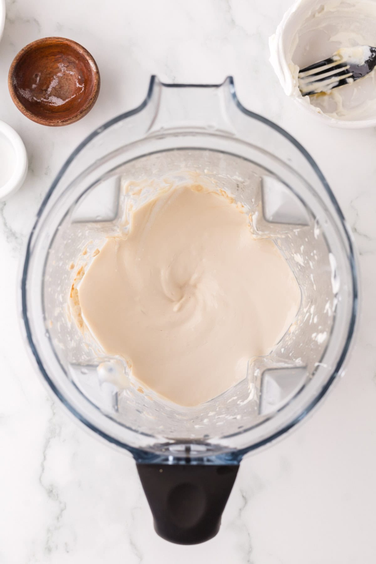 blender pitcher with the ingredients for the healthy no bake cheesecake recipe.