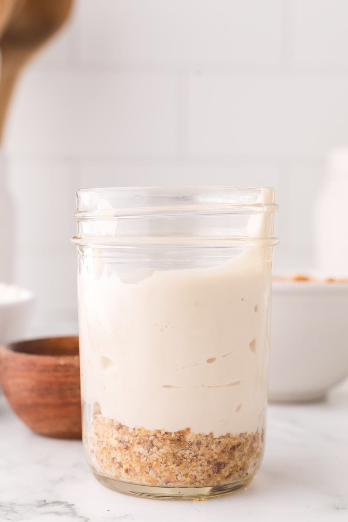 healthy no-bake cheesecake layered into a wide mouthed mason jar.