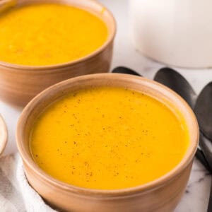 homemade butternut squash soup in two serving bowls.