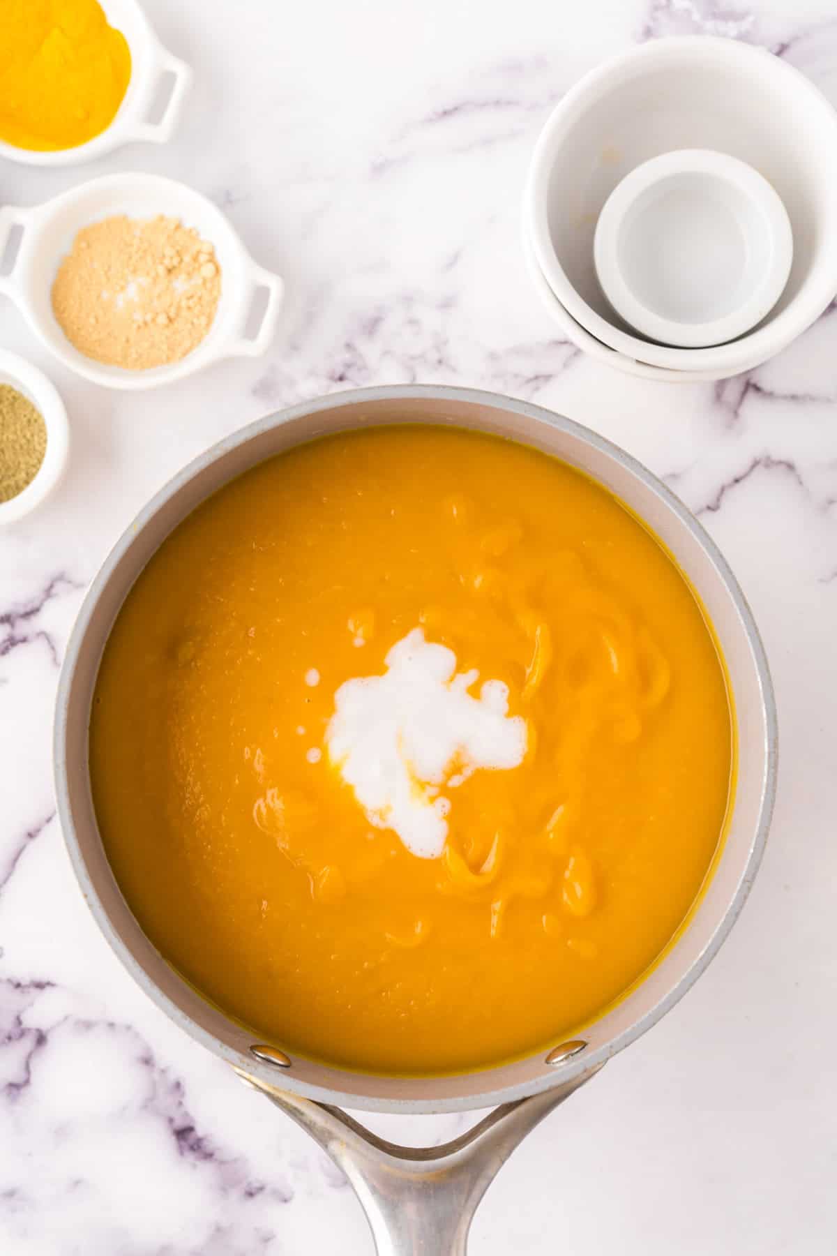 homemade butternut squash soup in progress in a sauce pan.