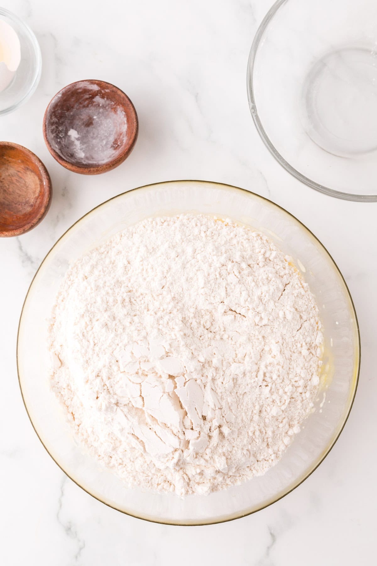 clear mixing bowl in the process of making honey pecan sliced cookies.