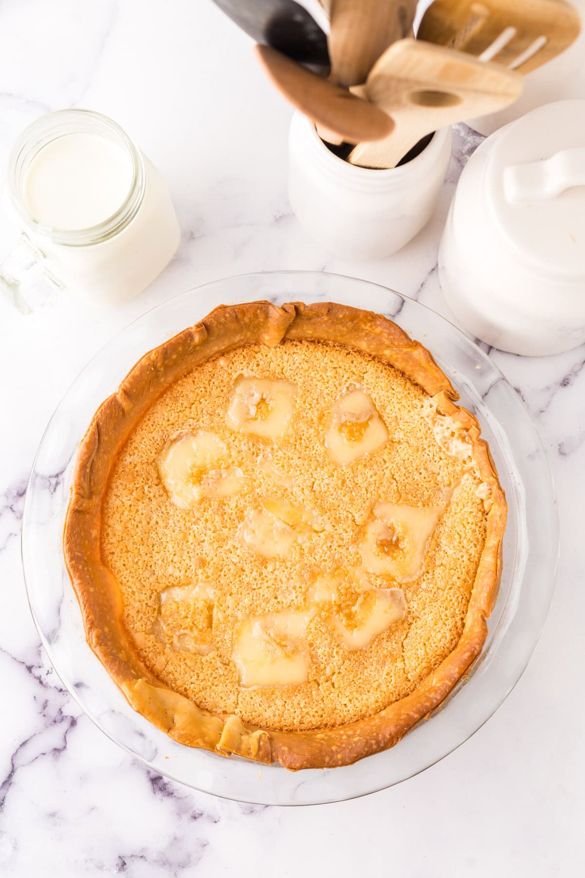 pie plate with the hoosier sugar cream pie baked inside.