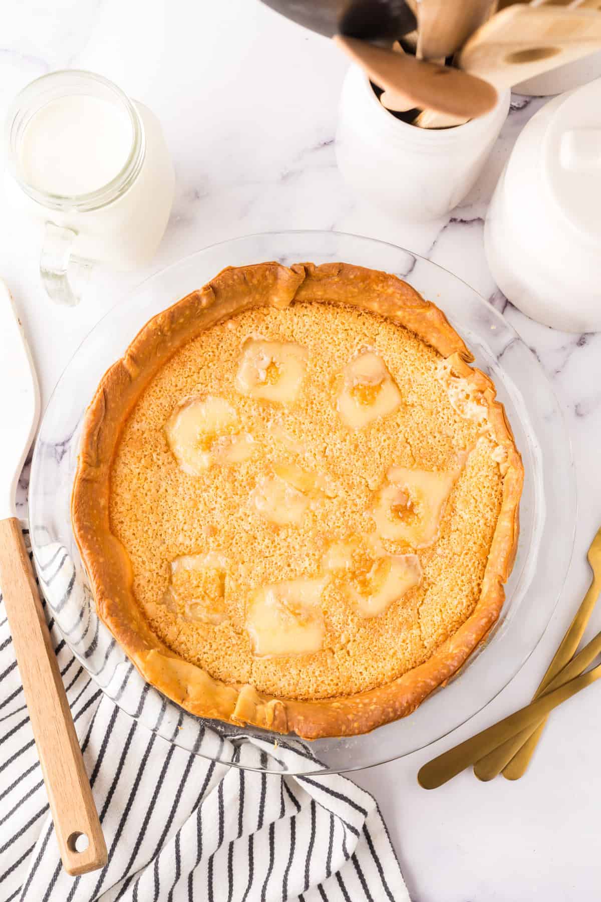 pie plate with the hoosier sugar cream pie baked inside.