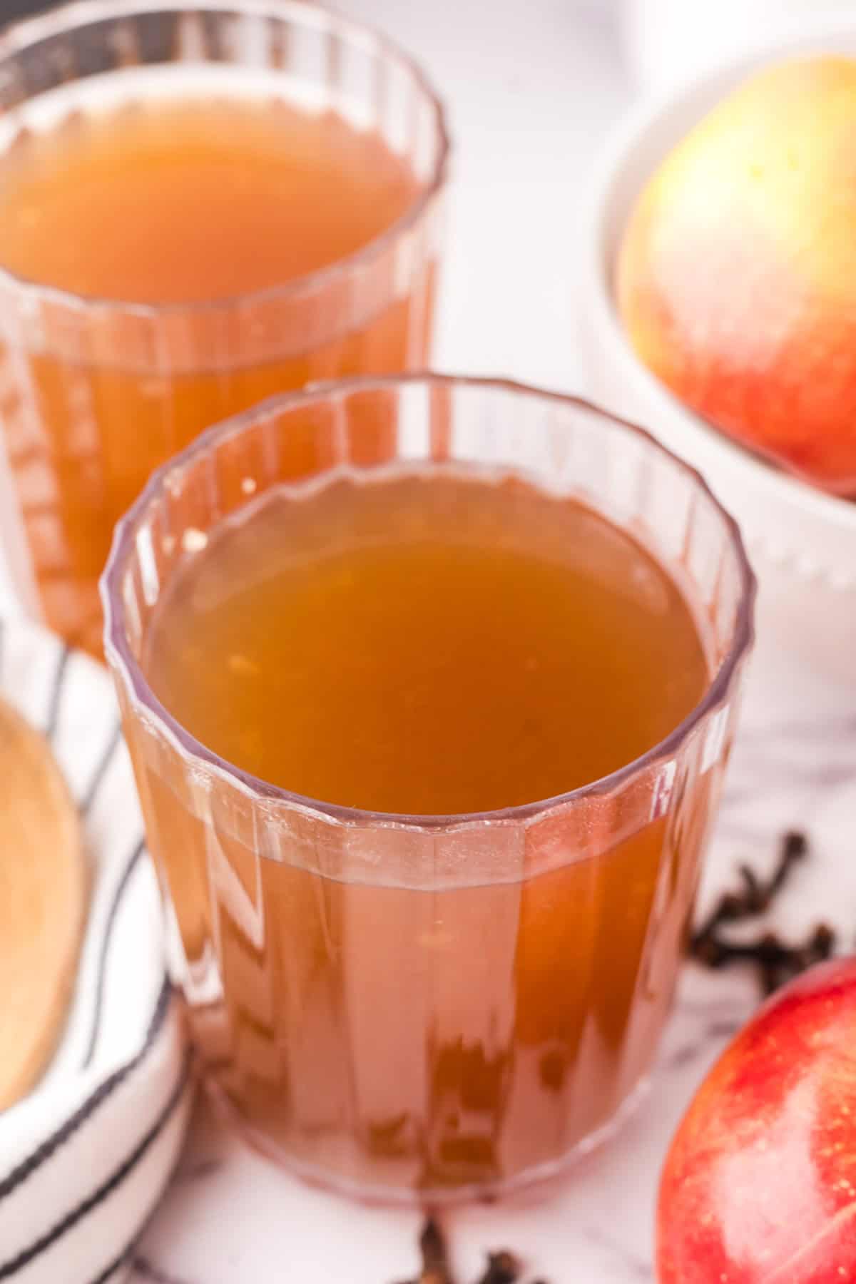 slow cooker apple cider in beautifully adorned glasses.